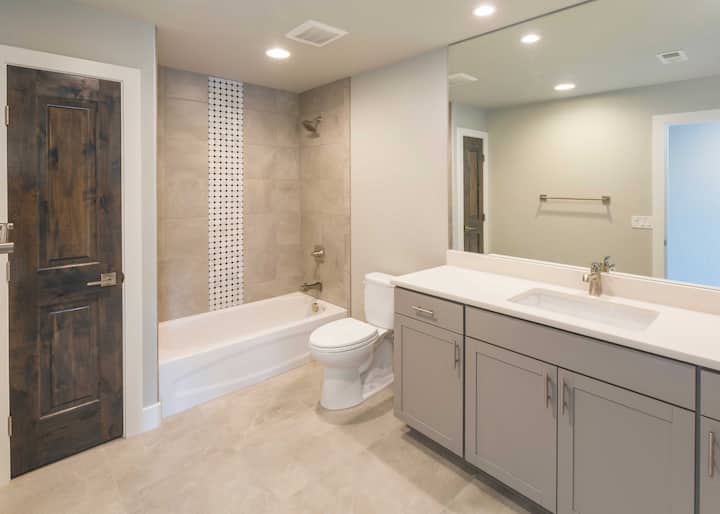 A polka dot shower and bathtub installation gives a Westminster, Colorado home a flair of luxury